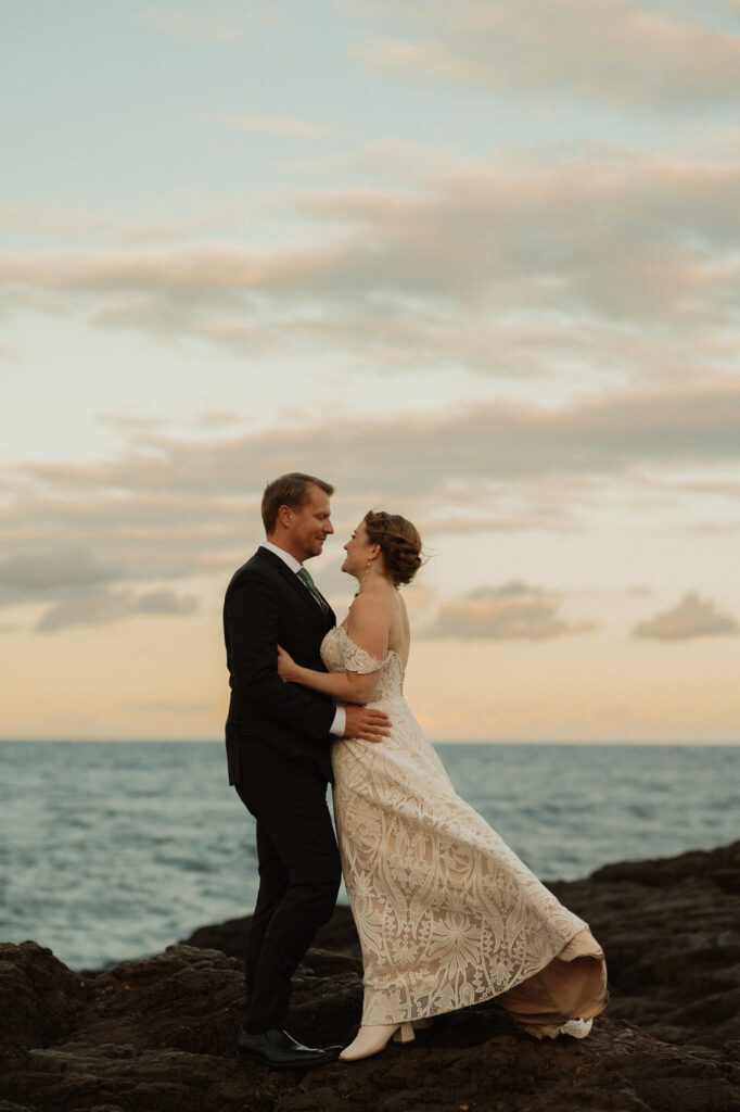 wind sweeps through bride's dress on lake superior