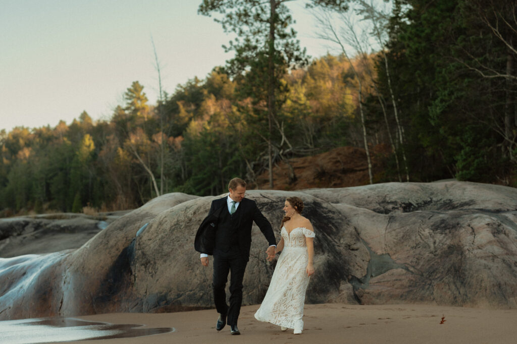 laughing couple on lake superior beach during wedding
