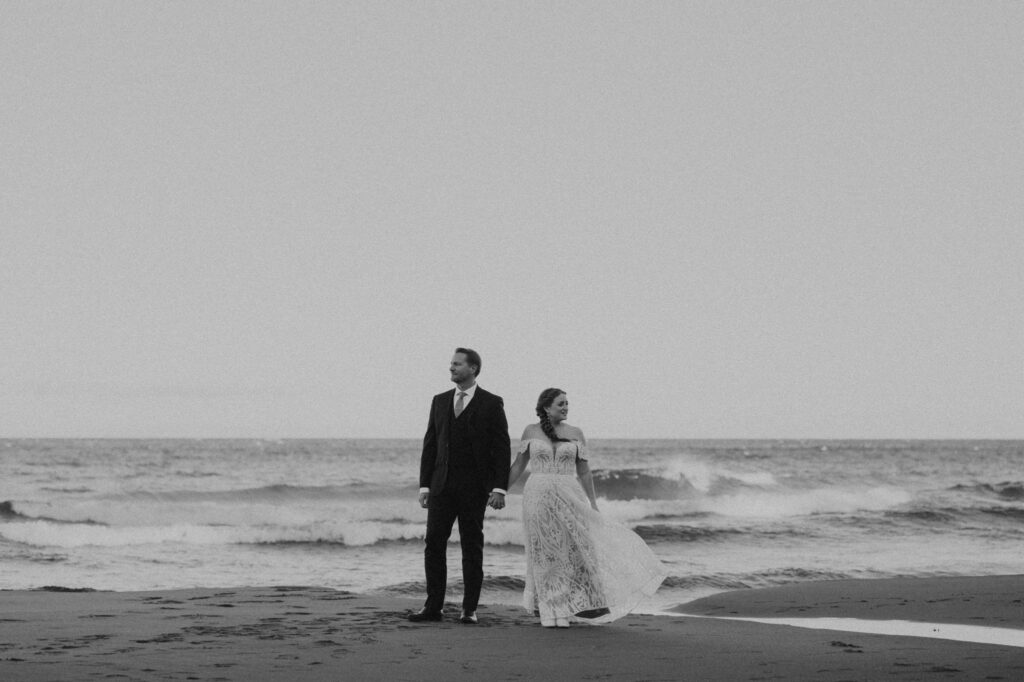 Couple standing hand-in-hand along the Lake Superior coast