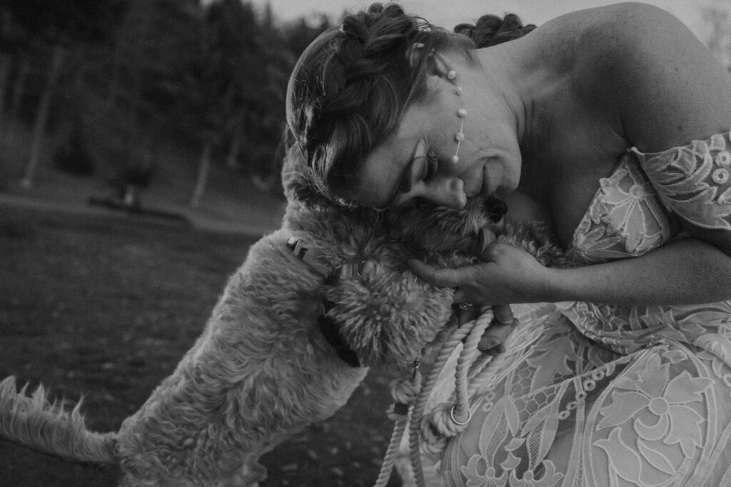 bride hugging her dog during michigan elopement