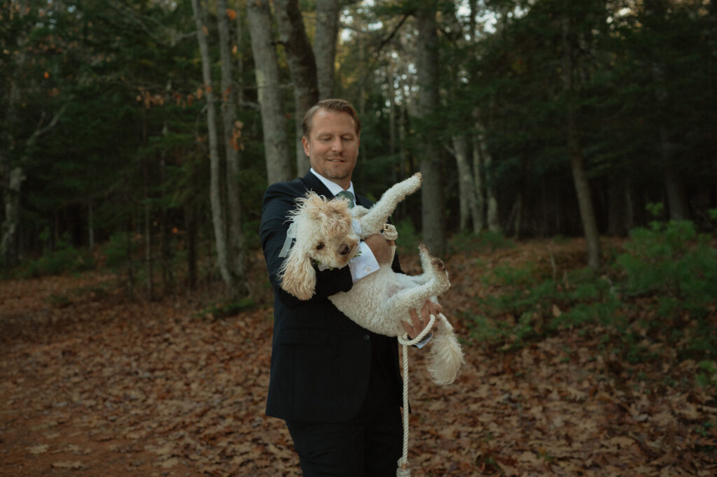 groom with dog during elopement