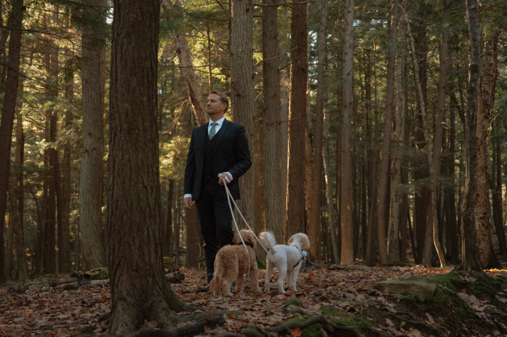 groom waiting with dogs for first look